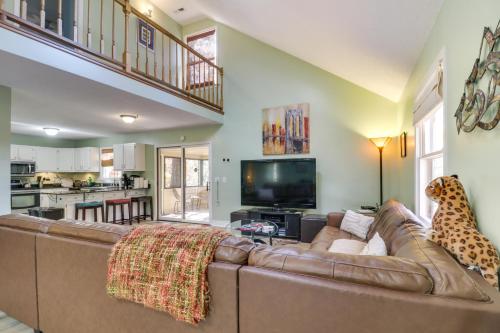 a living room with a brown couch and a television at Spacious Family Home with Deck at Massanutten Resort in McGaheysville
