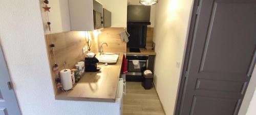 a small kitchen with a sink and a counter at Joli T2 + coin montagne + Garage in Briançon