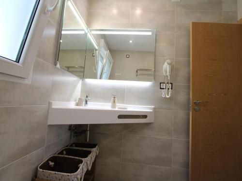 a bathroom with a sink and a mirror at Casa cerca del mar con piscina privada, aire opcional, wifi gratuito, mascotas y playas para perros - ES-184-60 in L'Ametlla de Mar