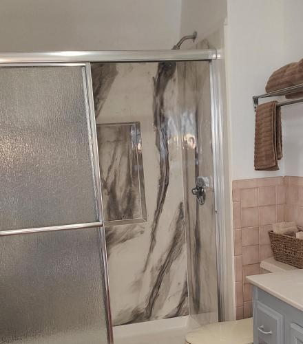 a shower with a glass door in a bathroom at The SIlo Retreat in Greene