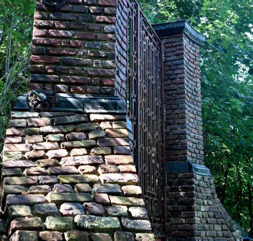 a gate on a brick wall with a fence at Col du Fatten in Beek