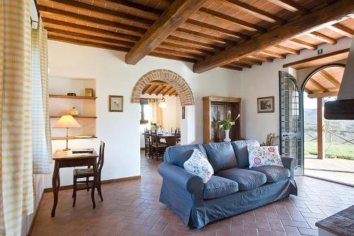 a living room with a blue couch and a table at Villa Miravalle in Pietraviva