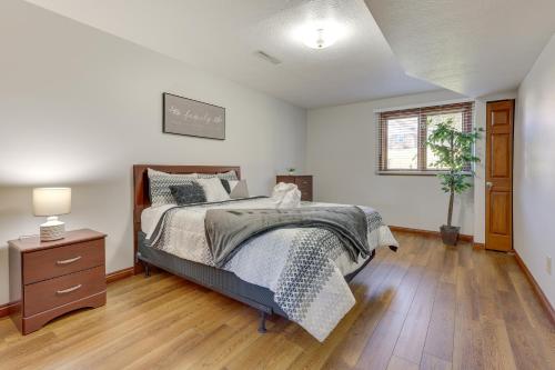 a bedroom with a bed and a wooden floor at Bolivar Getaway Near Pro Football Hall of Fame! in Bolivar