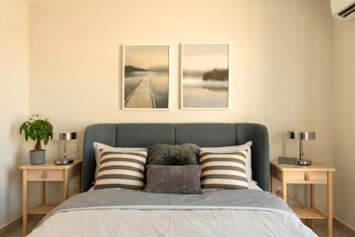 a bedroom with a bed with three pictures on the wall at Modern 3BD Spacious Apartment with Terrace - Close to Yacht Marina in Msida