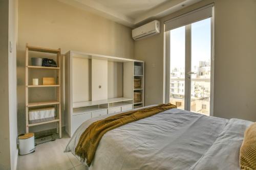 a bedroom with a bed and a large window at Modern 3BD Spacious Apartment with Terrace - Close to Yacht Marina in Msida