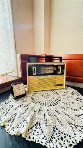 a radio sitting on top of a rug on a floor at Dezudava Family Hotel in Sandanski