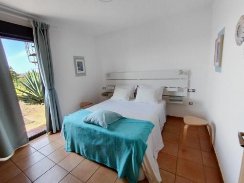 a bedroom with a bed and a large window at Marine Melody House - Perfect for relaxing getaway in Lajares