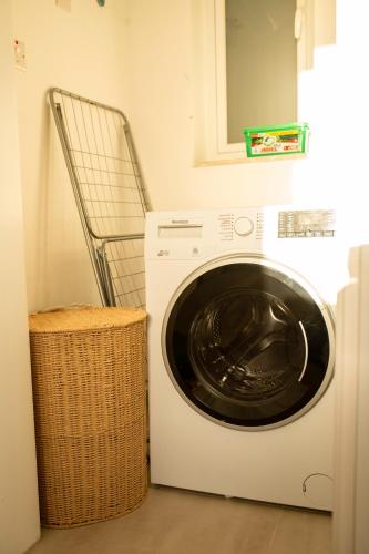 a washing machine in a laundry room with a basket at Modern 3BD Spacious Apartment with Terrace - Close to Yacht Marina in Msida