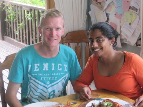 a man and a woman sitting at a table with a plate of food at Brook House B&B & Cottages in Kaikoura