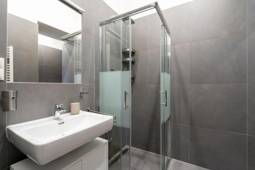 a bathroom with a sink and a shower at Cosy Apartment Naschmarkt I new furnished in Vienna