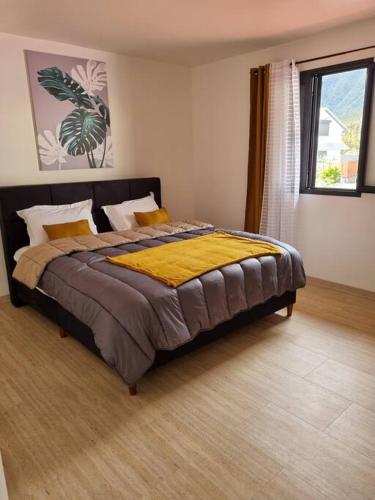 a bedroom with a large bed in a room at Villa Piton Textor in La Plaine des Palmistes