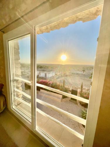 a window with a view of a desert view at Chill House surf camp in Sidi Kaouki