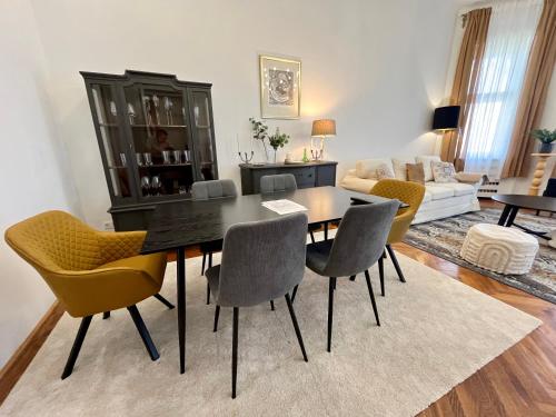 a living room with a dining room table and chairs at Hillside Luxury Residence Budapest with free garage in Budapest