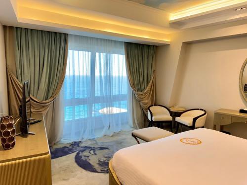 a hotel room with a bed and a large window at Fleet Club Mahrousa in Alexandria