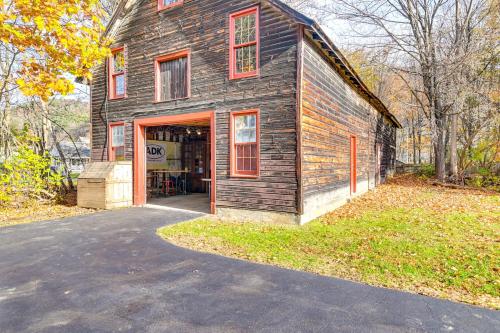 an old house with red windows and a garage at 6 Mi to Lake George Adirondack Home with Game Room in Warrensburg