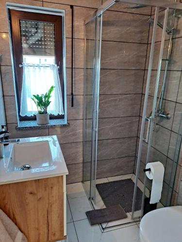 a bathroom with a shower and a sink at Złote Gąski in Gąski