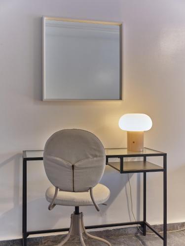 a desk with a chair and a table with a lamp at TheCasaEdition Gauthier Residency City Center in Casablanca