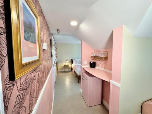 a hallway with a pink room with a bed at Peninsula Bed & Cocktails in St Petersburg