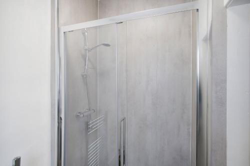 a glass shower door in a bathroom at Spacious Living Room & Modern Comforts, Sleeps 4 in Peterlee