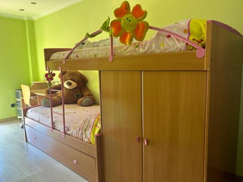 a bunk bed with a teddy bear in a room at Casa con jacuzzi y piscina con vistas al castillo in Corbera de Alcira