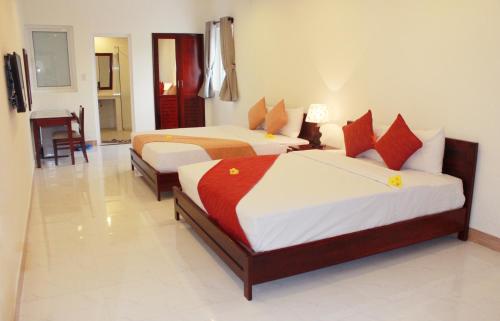 Een bed of bedden in een kamer bij Ha Anh Hotel - Mui Ne
