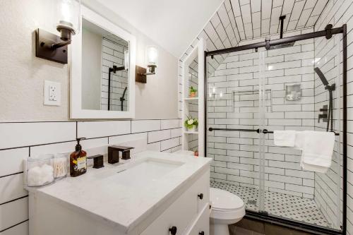 a white bathroom with a sink and a toilet at Updated Denver Home Near Parks, Dining and Shops! in Denver