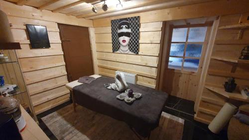 a room with a bed in a wooden room at Apartments Beskydy in Prostřední Bečva