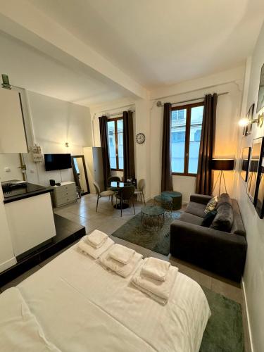 un salon avec un lit et un canapé dans l'établissement Temple Apartments Paris, à Paris