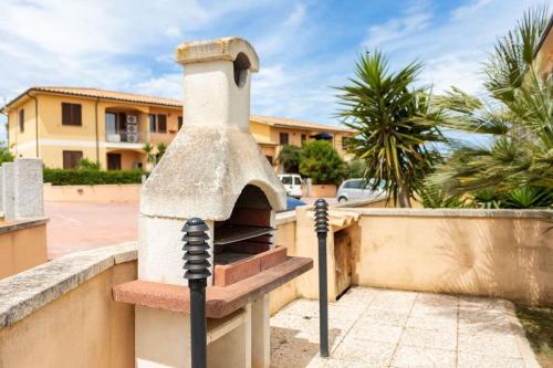 a stone oven in front of a house at [2 KM DAL MARE] Villetta relax con barbecue in Palmadula