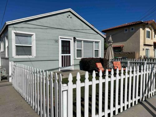 a white picket fence in front of a house at Entire Home by Newport Beach, Disneyland and SNA! in Costa Mesa