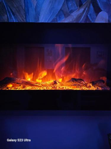a fire in an oven with flames in it at Apartament Blisko Natury in Olsztyn