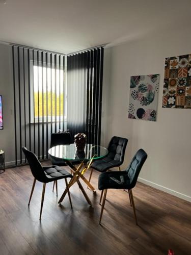 a dining room with a glass table and chairs at Mieszkaj U Marty w GRÓDKU in Jaworzno