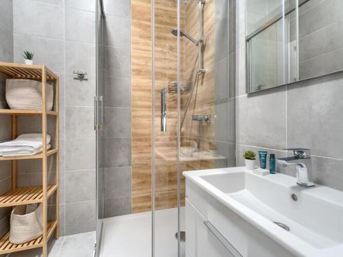 a bathroom with a shower and a sink and a shower at Apartment with beautiful view, Dziwnów in Dziwnów