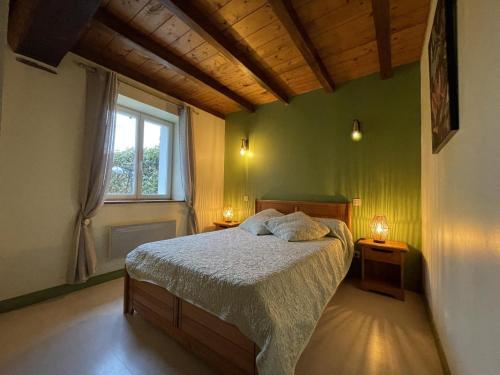 a green bedroom with a bed and a window at Haizalde in Saint-Jean-le-Vieux