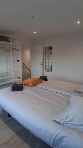 a large white bed sitting in a room at Huize Clementina in Peer