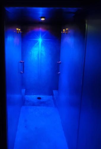a bathroom with blue lights and a dark room at Azcapri Villa Boutique & Spa in Cancún