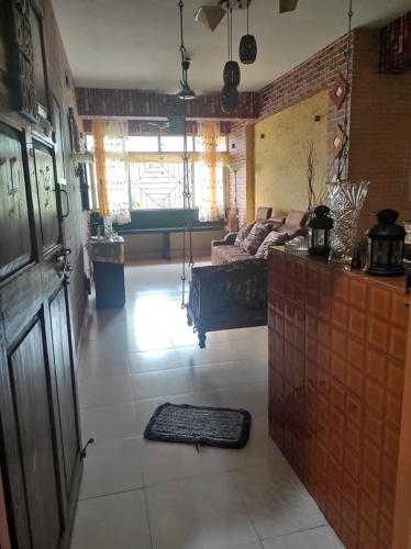 a living room with a couch and a pool table at ULTIMUS Homestay in Barrancabermeja