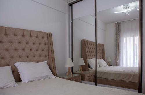 a bedroom with two beds and a large mirror at Stefan Apartments in Budva in Budva