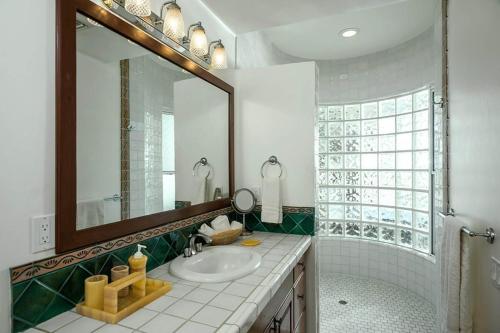 a bathroom with a sink and a mirror at Sunset View Villa Pedregal in Cabo San Lucas