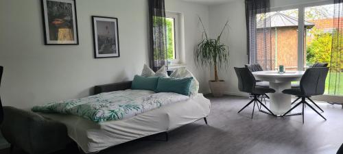 a bed in a room with a table and chairs at Monteurwohnung in Bad Neustadt an der Saale