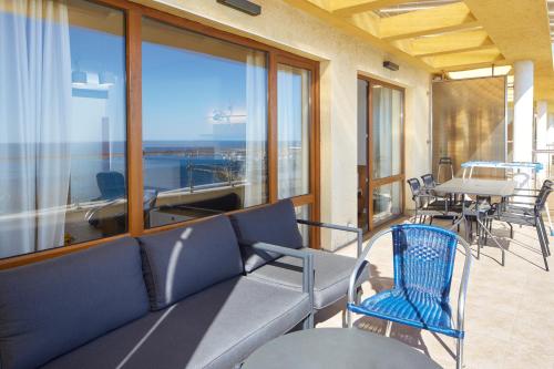 a balcony with a couch and chairs and a table at Infinity Terrace 1BR Apartment Nessebar in Nesebar