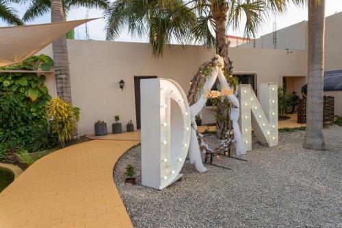 a sign that says love in front of a building at Azcapri Villa Boutique & Spa in Cancún