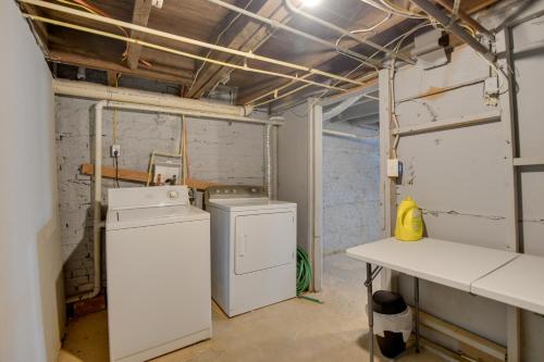 a laundry room with a washer and dryer in it at Cozy Maryland Getaway in the Heart of Baltimore! in Baltimore