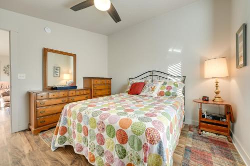 a bedroom with a bed and a dresser and a mirror at Pet-Friendly White Pigeon Apartment with Fire Pit! in White Pigeon