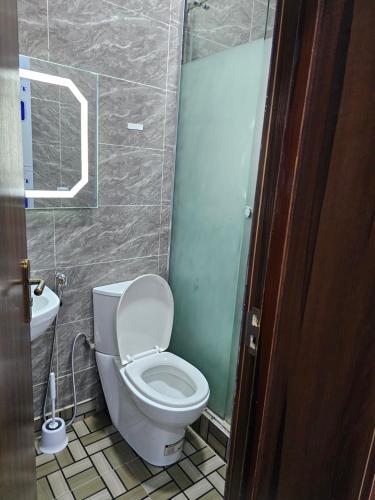 a bathroom with a toilet and a sink at APARTMENT 001 in Lagos