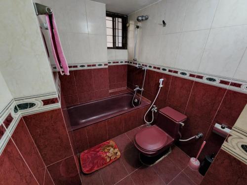 a bathroom with a toilet and a bath tub at Dhanmondi Furnished Lake View Apartment in Dhaka