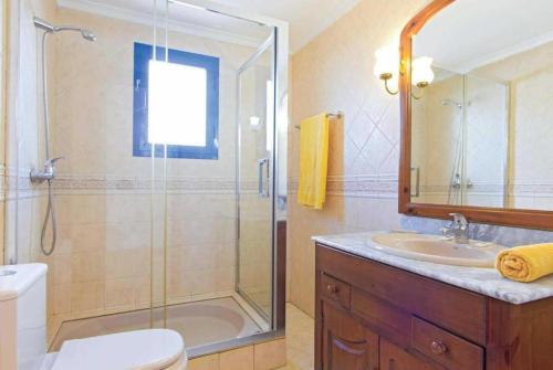 a bathroom with a shower and a toilet and a sink at Villa Acomari in Playa Blanca