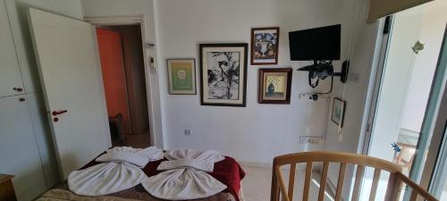 a room with three pillows on a bed at Astrofegia Apartments Near The Sea in Ayia Marina