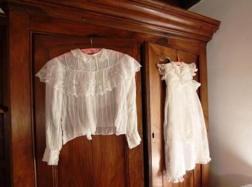 two white dresses hanging on a wooden door at Behiagoitia in Larrau
