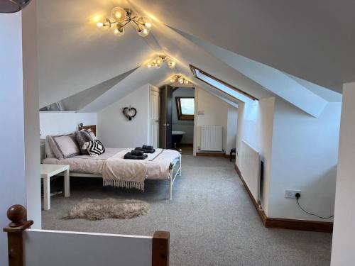 a bedroom with a bed in a attic at Family & friends get together birthday hot tub in Porthcawl